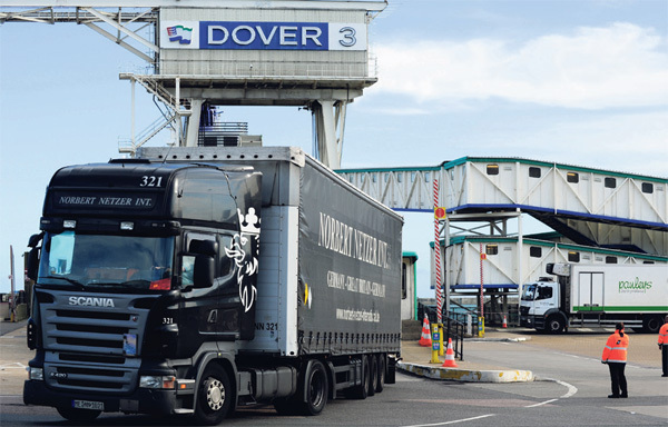 Car shipping company truck at Dover Port for international vehicle shipping.