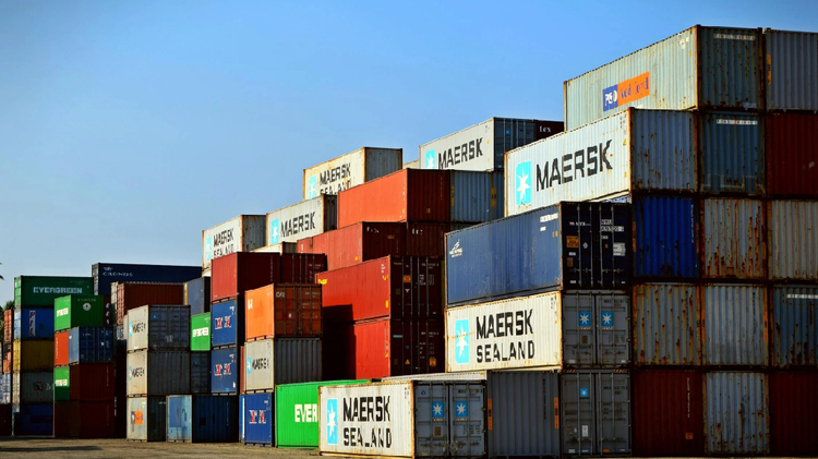 Shipping containers stacked for vehicle import and export by sea freight