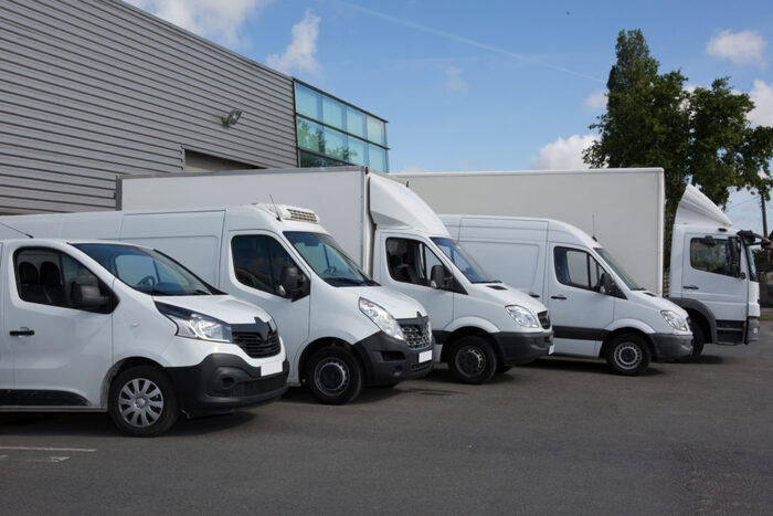 Shipping vehicles at a UK car shipping company and logistics depot.