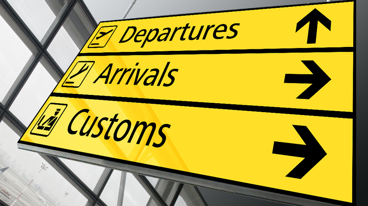 Overseas motorcycle shipping with airport customs and international arrivals signage