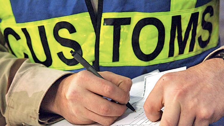 Customs officer completing temporary vehicle import and export documentation