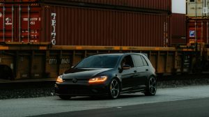 Personal vehicle near shipping containers prepared for UK car import or export