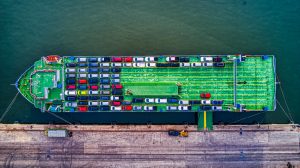 Aerial view of RoRo vessel loading commercial vehicles at UK port